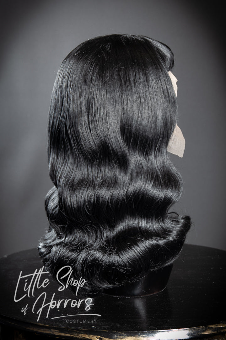 Paying homage to the one and only, the Notorious Bettie Page, who "never was the girl next door". Often referred to as the Queen of Pinups, her liberated sexuality and iconic look has influenced style for generations. This wig is a Bettie Page themed vintage 1950s pinup style with of course, those iconic bangs. Available to order at Little Shop of Horrors Costumery & Pop Culture Emporium, Melbourne's Wig Styling Specialists. 6/1 Watt Rd Mornington.