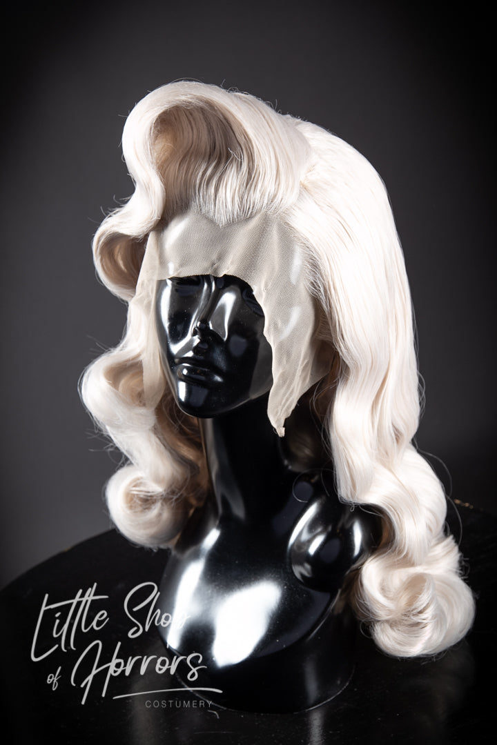Introducing our mesmerizing "Kiss the Boys Goodbye" styled lace front wig, a breathtaking vintage creation adorned with luxuriously soft waves that cascade elegantly to create a truly stunning look. Little Shop of Horrors Costumery & Pop-Culture Emporium 6/1 Watt Rd Mornington Melbourne Australia