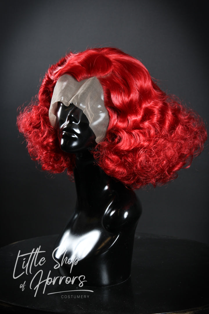 Our "Puttin' on the Ritz" wig exudes the stunning vintage vibes of the 1920s/1930s, reminiscent of prohibition parties and smokey jazz clubs. It features a gorgeous vintage set with a Marcel wave and an abundance of glamorous curls. Available to order at Little Shop of Horrors Costumery & Pop Culture Emporium, Melbourne's Wig Styling Specialists. 6/1 Watt Rd Mornington.
