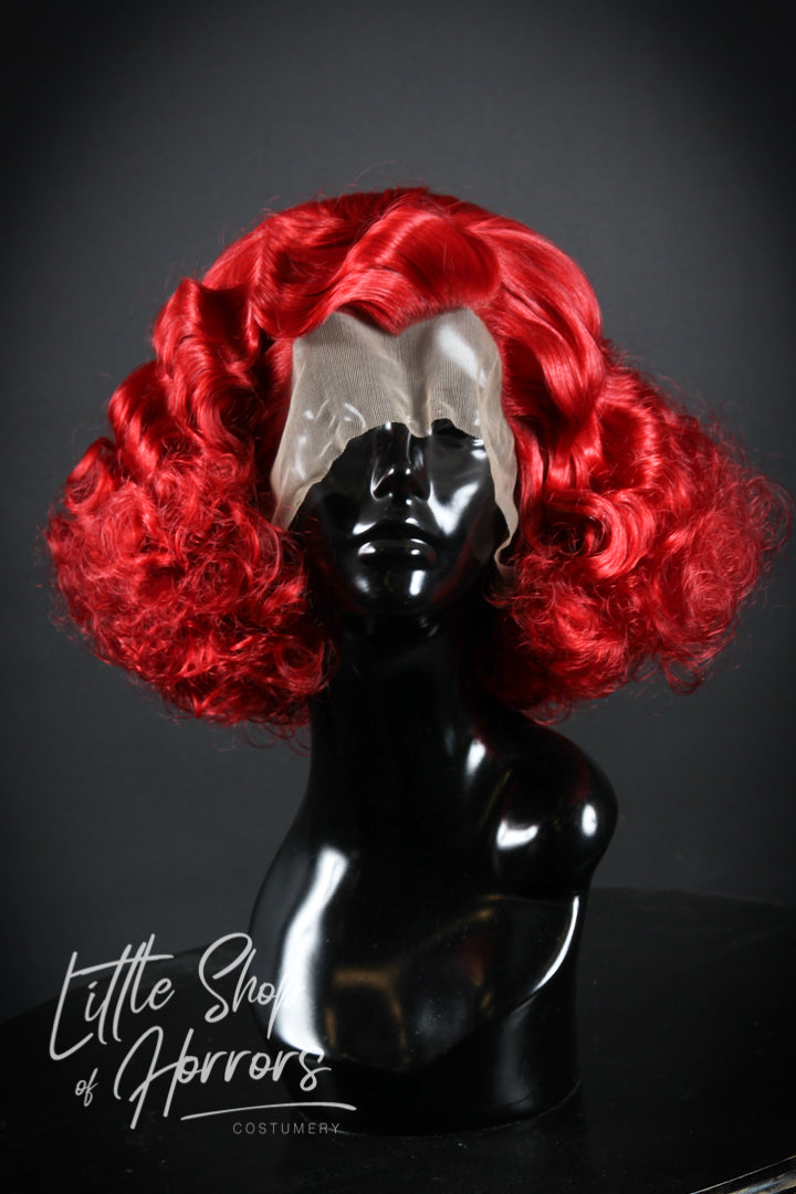 Our "Puttin' on the Ritz" wig exudes the stunning vintage vibes of the 1920s/1930s, reminiscent of prohibition parties and smokey jazz clubs. It features a gorgeous vintage set with a Marcel wave and an abundance of glamorous curls. Available to order at Little Shop of Horrors Costumery & Pop Culture Emporium, Melbourne's Wig Styling Specialists. 6/1 Watt Rd Mornington.