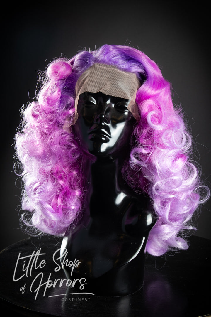 Our "Super Freak" 1970s disco styled lace front wig, exudes playful 1970s disco vibes. Picture a soft Marcel Wave cascading into abundant, fluffy curls. Pair it with champagne, roller skates, and groovy disco tunes for the ultimate retro experience!Available to order at Little Shop of Horrors Costumery & Pop Culture Emporium, Melbourne's Wig Styling Specialists. 6/1 Watt Rd Mornington.